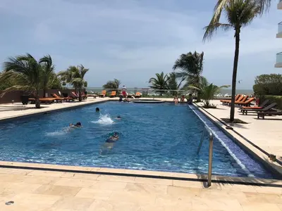 a group of people swimming in a large swimming pool at morros 3 in Cartagena de Indias