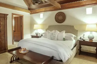 a bedroom with a large white bed and a table at Hotel Casa San Agustin in Cartagena de Indias