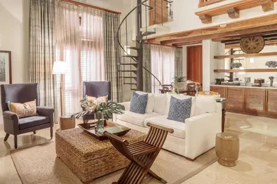 a living room with a white couch and two chairs at Hotel Casa San Agustin in Cartagena de Indias