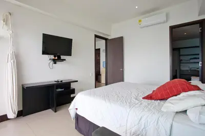 a bedroom with a bed and a tv on the wall at Palmetto Eliptic 4003 in Cartagena de Indias