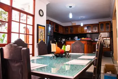 a dining room with a table and a kitchen at Casa Fanny in Cartagena de Indias