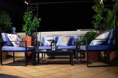 a group of blue chairs and a table on a patio at Casa Fanny in Cartagena de Indias