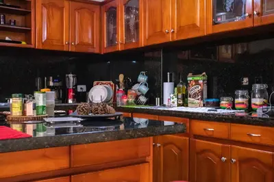 a kitchen with wooden cabinets and a plate of food at Casa Fanny in Cartagena de Indias