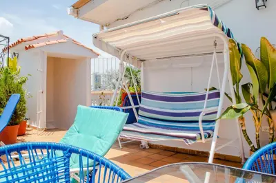 a porch with chairs and a swing on a balcony at Casa Fanny in Cartagena de Indias