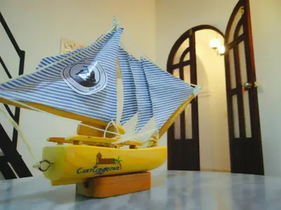 a yellow boat with a blue and white umbrella on a table at Cartagena Legends in Cartagena de Indias