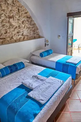 three beds in a room with blue and white at Cartagena Legends in Cartagena de Indias