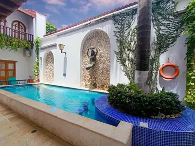 a swimming pool in the courtyard of a house at Cartagena Legends in Cartagena de Indias