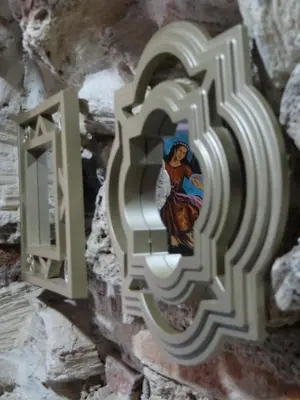 a cross on a wall with a painting on it at Cartagena Legends in Cartagena de Indias