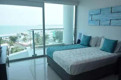 a bedroom with a bed and a view of the ocean at Modern 3 Bedroom Apartment with sea-beach view in Cartagena de Indias