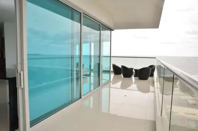 a room with glass walls and two black chairs at Modern 3 Bedroom Apartment with sea-beach view in Cartagena de Indias