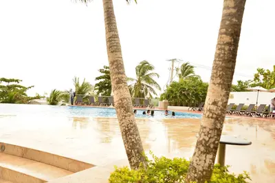 a pool with palm trees and people in the water at Modern 3 Bedroom Apartment with sea-beach view in Cartagena de Indias