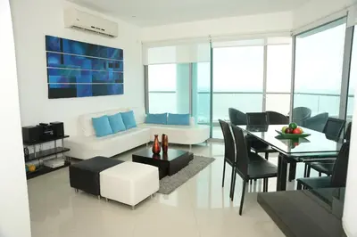 a living room with a table and a couch at Modern 3 Bedroom Apartment with sea-beach view in Cartagena de Indias