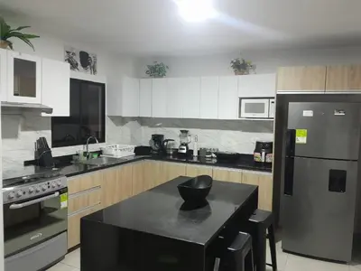 a kitchen with a black island in the middle at Villa Las Marias in Santa Veronica