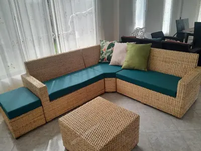 a wicker couch with a bench and a table at Villa Las Marias in Santa Veronica