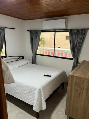 a bedroom with a white bed and a window at Villa Las Marias in Santa Veronica