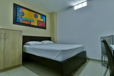 a small bedroom with a bed with a cabinet at Genesis Hotel in Sincelejo