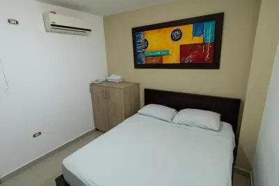 a bedroom with a bed and a painting on the wall at Genesis Hotel in Sincelejo