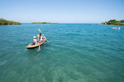 a group of people in a boat in the water at Isla Tijereto in Isla Grande