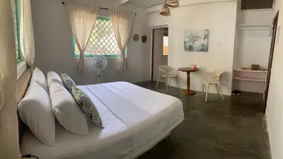 a bedroom with a large bed with white sheets and pillows at Isla Tijereto in Isla Grande