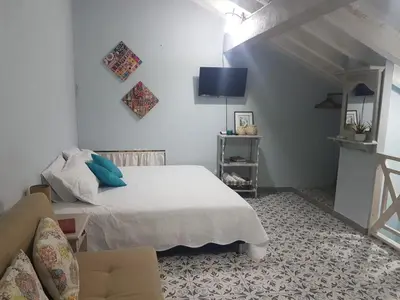 a white bedroom with a bed and a couch at Casa Anita in Cartagena de Indias