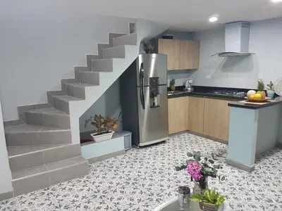 a kitchen with a staircase leading up to a refrigerator at Casa Anita in Cartagena de Indias