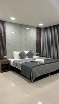 a bedroom with a large bed with black curtains at Bahia 79 Apartasuites Cerca al Centro in Cartagena de Indias