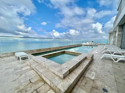 a swimming pool with a view of the ocean at Apartamento en Cartagena con Vista al Mar in Cartagena de Indias