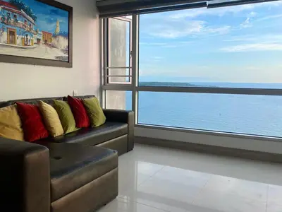 a living room with a couch and a large window at Apartamento en Cartagena con Vista al Mar in Cartagena de Indias