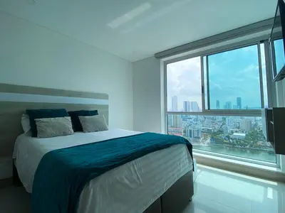 a bedroom with a bed and a large window at Apartamento en Cartagena con Vista al Mar in Cartagena de Indias