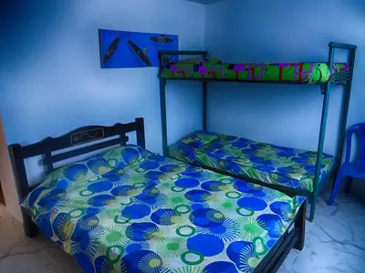 a bedroom with two bunk beds in a blue room at Casa Hotel Nurandy in Cartagena de Indias