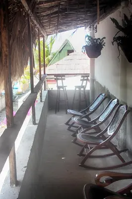 a row of chairs lined up on a patio at Casa Hotel Nurandy in Cartagena de Indias