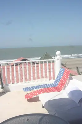 an american flag bench on a balcony with the beach at Casa Hotel Nurandy in Cartagena de Indias
