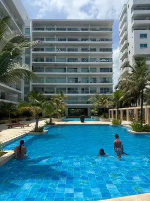 a group of people in a swimming pool in front of a building at Apartamento Cartagena Morros Epic 25 in Cartagena de Indias