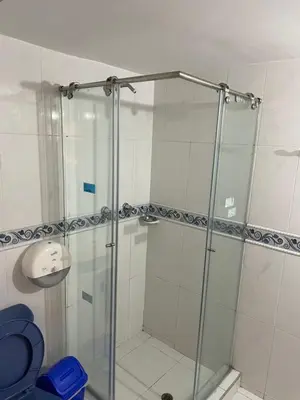 a shower with a glass door in a bathroom at Alojamientos Cartagena Edificio Los Delfines in Cartagena de Indias
