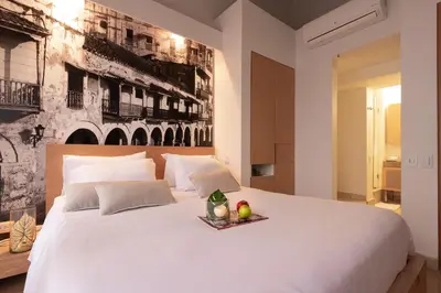 a large white bed with a tray of fruit on it at Delirio Hotel in Cartagena de Indias