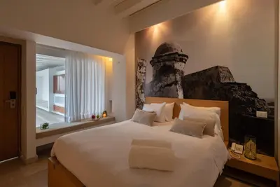 a bedroom with a large white bed and a window at Delirio Hotel in Cartagena de Indias