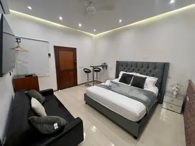 a bedroom with a bed and a couch at Luxury Suite Room in Cartagena de Indias