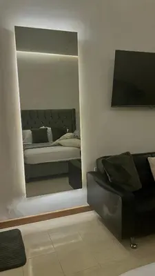 a living room with a couch and a mirror at Luxury Suite Room in Cartagena de Indias