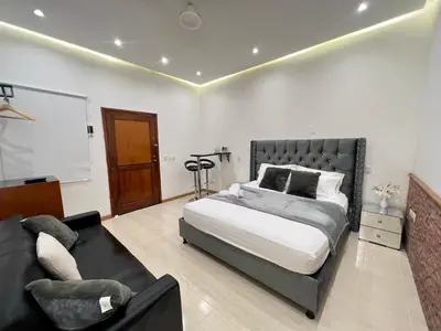 a bedroom with a large bed and a couch at Luxury Suite Room in Cartagena de Indias