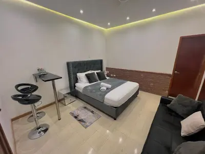 a bedroom with a bed and a couch at Luxury Suite Room in Cartagena de Indias