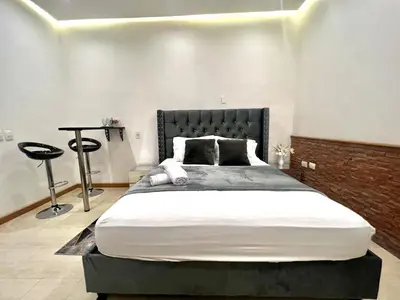 a bedroom with a large bed with a black headboard at Luxury Suite Room in Cartagena de Indias