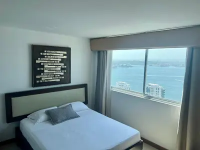a bedroom with a bed and a large window at Palmetto Suite Superior 3901 in Cartagena de Indias