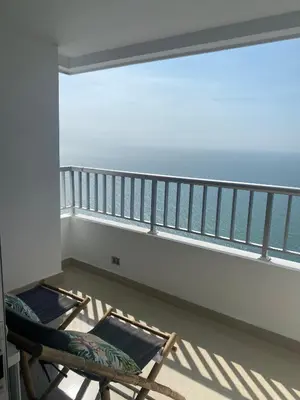 a balcony with two chairs and a view of the ocean at Palmetto Suite Superior 3901 in Cartagena de Indias