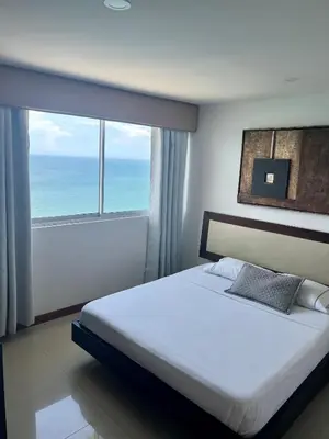 a bedroom with a bed and a large window at Palmetto Suite Superior 3901 in Cartagena de Indias