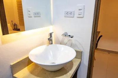 a bathroom with a white bowl sink on a counter at Hotel Amoek in Cartagena de Indias