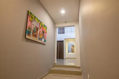 a hallway with a painting hanging on a wall at Hotel Amoek in Cartagena de Indias