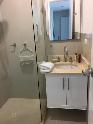a bathroom with a shower and a sink and a mirror at Apartamento Confort Frente a la Playa en Cartagena! in Cartagena de Indias