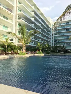 a swimming pool in front of a large building at Apartamento Confort Frente a la Playa en Cartagena! in Cartagena de Indias