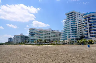 a view of a beach with buildings in the background at Cartagena Beach Front Apartments in Cartagena de Indias