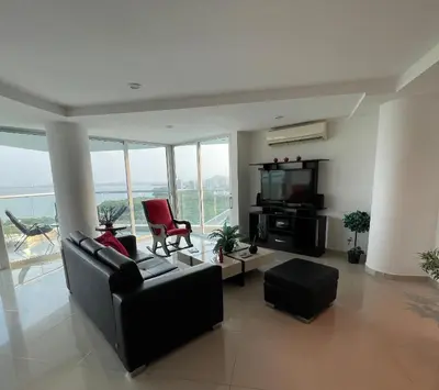 a living room with a black couch and a tv at Cartagena Beach Front Apartments in Cartagena de Indias